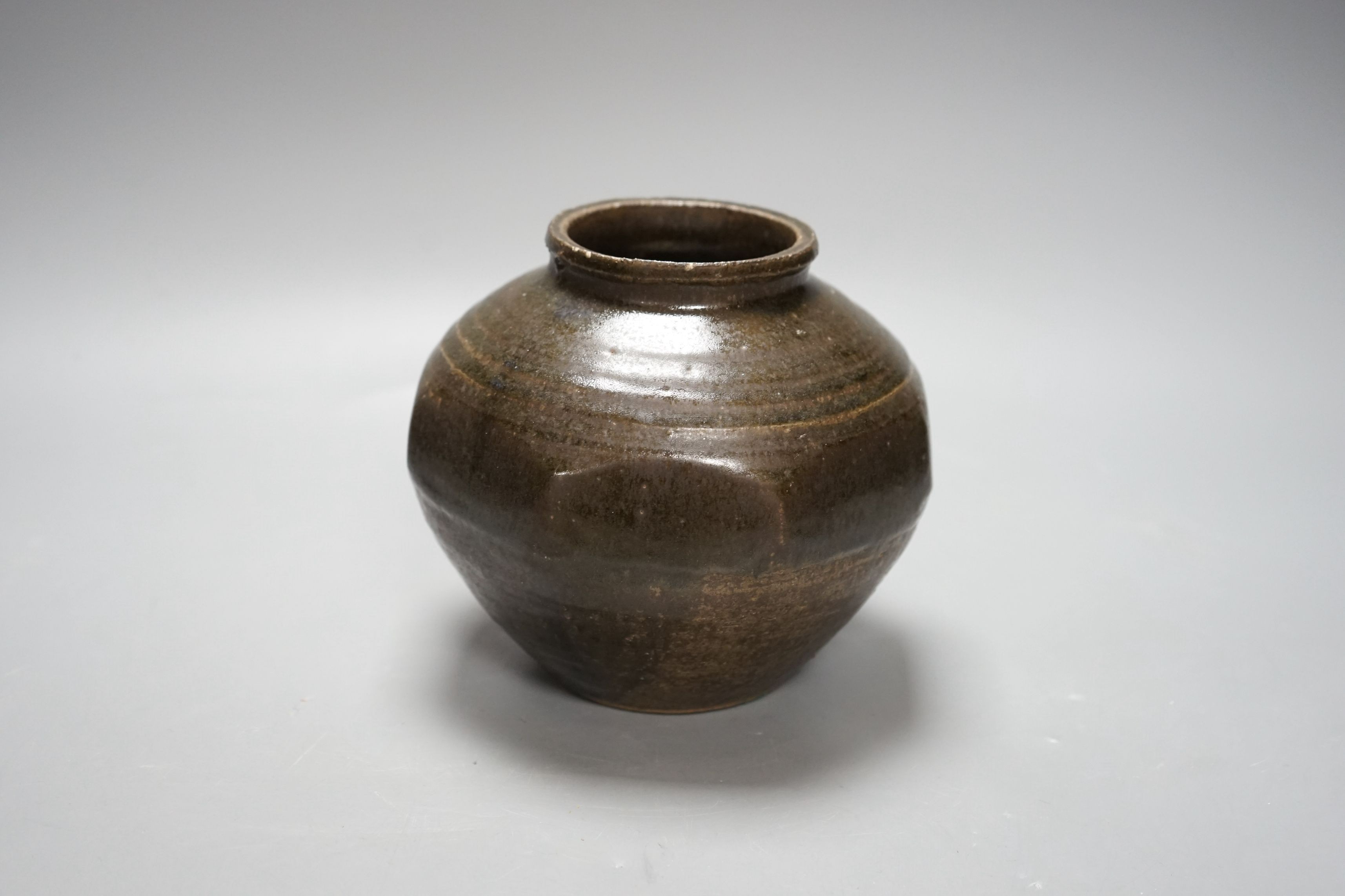 Attributed to Robert Fournier, but possibly by Ray Finch, a tenmoku glazed cut sided ovoid pot, ex Bonhams, 2nd December sale 1989, lot 209, impressed mark to rim, 15cm tall